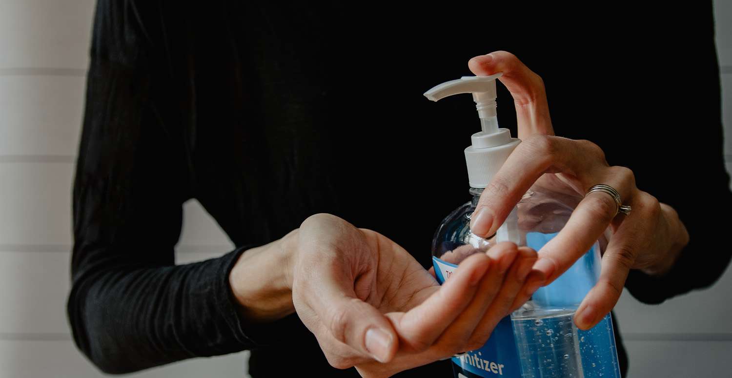 Woman using hand sanitizer