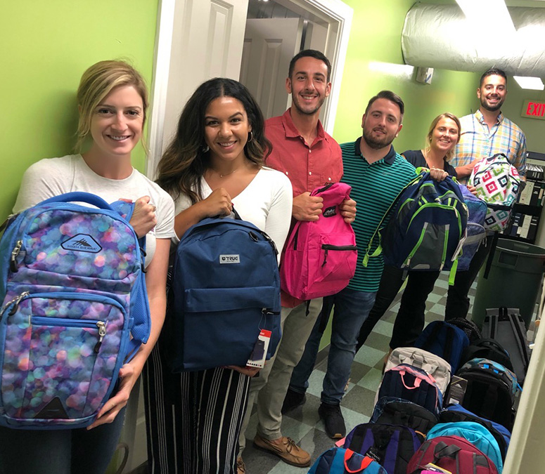 Curate Partners team members supporting the Malden Housing Families backpack drive